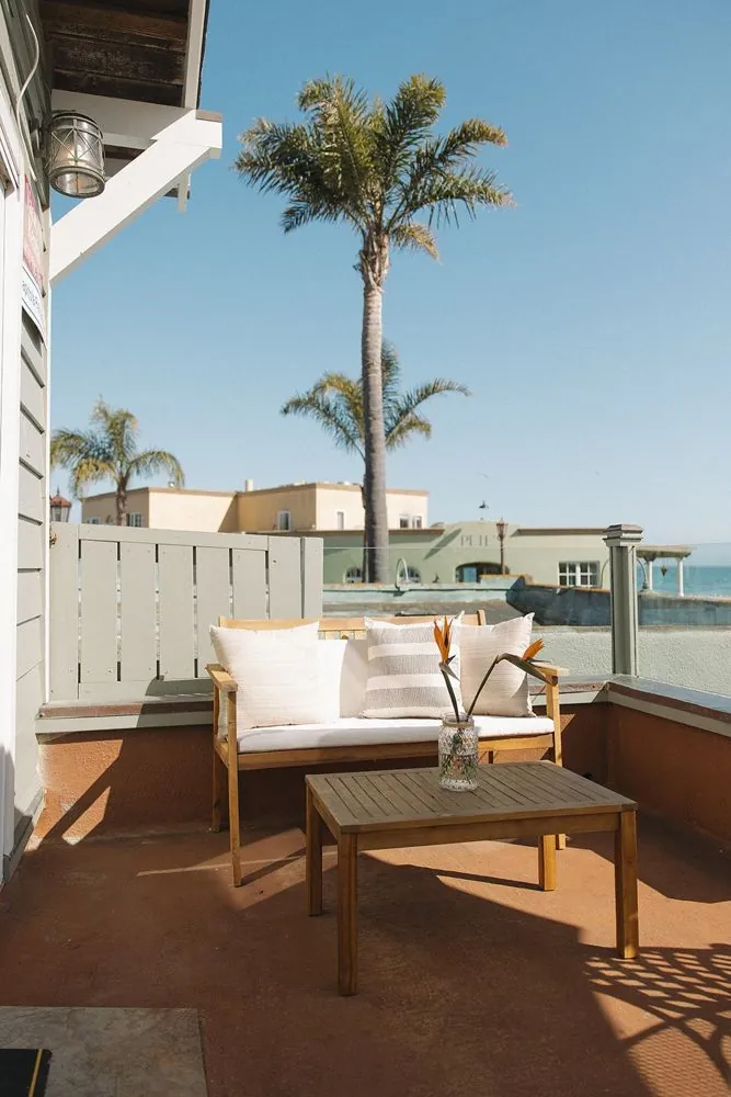 Deck lounge chairs under a palm