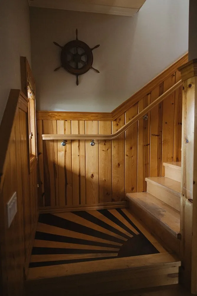Wood stairwell with ship's wheel